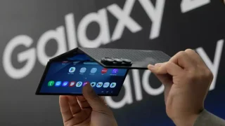 Samsung Galaxy Z TriFold phone undergoing durability test with visible hinge.