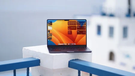 Silver MacBook Pro with M5 chip on wooden desk